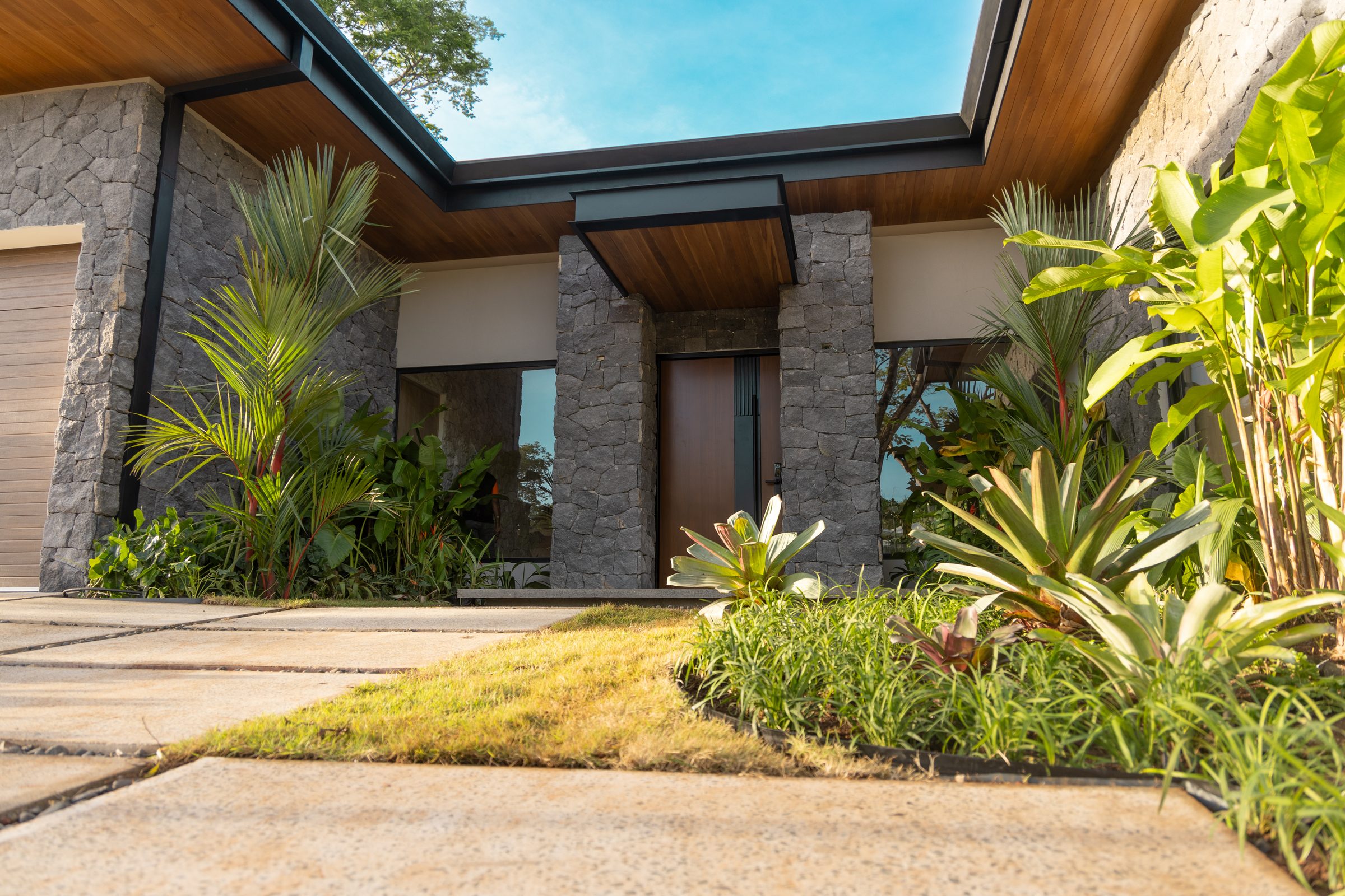 The entry of a finished home, set into its planting
